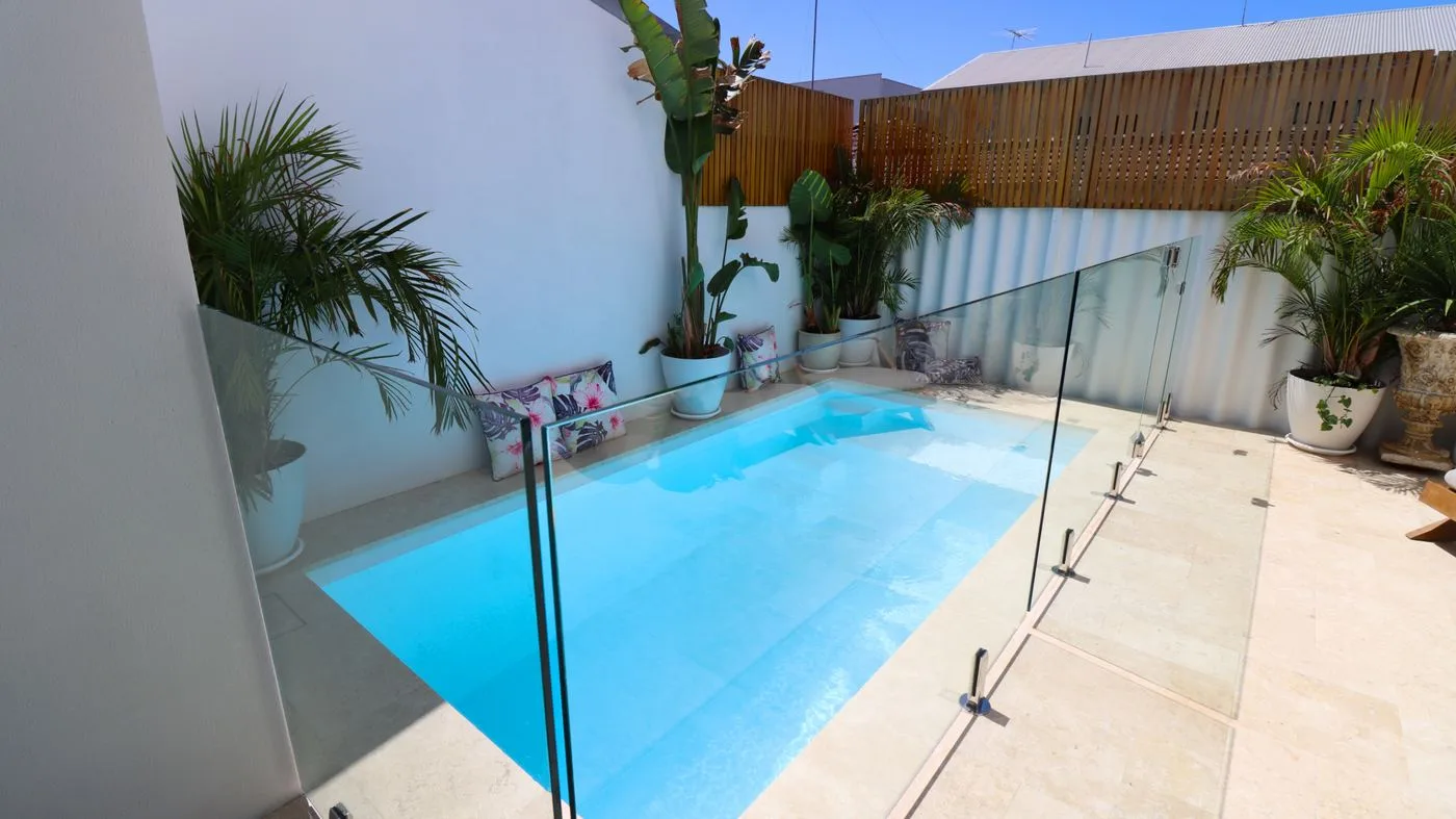 Aerial view of the Crystal Retreat pool fitted tightly between a house wall and boundary fence
